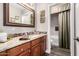 Bathroom with a granite countertop, decorative mirror and mosaic tile backsplash at 902 W Desert Valley Dr, San Tan Valley, AZ 85143