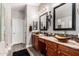 Primary bathroom with double sinks and wood cabinets at 902 W Desert Valley Dr, San Tan Valley, AZ 85143