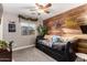 bedroom with playful decor, a wood accent wall and ample natural light at 902 W Desert Valley Dr, San Tan Valley, AZ 85143