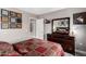 Well-lit bedroom featuring a mirrored dresser and decorative art at 902 W Desert Valley Dr, San Tan Valley, AZ 85143