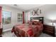 Cozy bedroom with a large window and decorative wall art, creating a comfortable retreat at 902 W Desert Valley Dr, San Tan Valley, AZ 85143