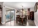 Dining room with a sliding door leading to the backyard and a table for six at 902 W Desert Valley Dr, San Tan Valley, AZ 85143