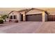 Attractive single-Gathering home with a brick driveway, manicured landscaping, and a welcoming two-car garage at 902 W Desert Valley Dr, San Tan Valley, AZ 85143