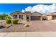 Charming single-story home with a well-manicured front yard and a two-car garage, exuding curb appeal at 902 W Desert Valley Dr, San Tan Valley, AZ 85143