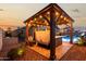 Relaxing hot tub under a wooden gazebo, equipped with lights and fans, perfect for evening relaxation at 902 W Desert Valley Dr, San Tan Valley, AZ 85143