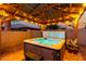 Inviting hot tub with mood lighting under a well-lit gazebo, creating a tranquil space for relaxation and enjoyment at 902 W Desert Valley Dr, San Tan Valley, AZ 85143