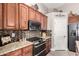 Close up of kitchen featuring granite countertops, stainless steel appliances, and wood cabinets at 902 W Desert Valley Dr, San Tan Valley, AZ 85143