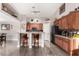 Stylish kitchen with dark wood cabinets, granite countertops, and bar seating at 902 W Desert Valley Dr, San Tan Valley, AZ 85143