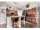 Charming kitchen featuring a breakfast bar with granite countertops and wood cabinets at 902 W Desert Valley Dr, San Tan Valley, AZ 85143