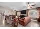 Spacious living room featuring ceiling fans, a large TV, and comfortable seating at 902 W Desert Valley Dr, San Tan Valley, AZ 85143