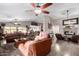 Open-concept living room with abundant seating, a fireplace, and a relaxing atmosphere at 902 W Desert Valley Dr, San Tan Valley, AZ 85143