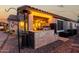 Well-equipped outdoor kitchen featuring a built-in grill, brick accents, and ample counter space for cooking at 902 W Desert Valley Dr, San Tan Valley, AZ 85143