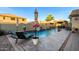 Inviting pool and lounge area features colorful umbrellas and a spa for relaxation, set against a sunny sky at 902 W Desert Valley Dr, San Tan Valley, AZ 85143