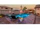 Gorgeous pool with colorful umbrellas, chaise lounges, a spa and a waterfall feature for relaxation and entertainment at 902 W Desert Valley Dr, San Tan Valley, AZ 85143