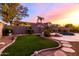 This backyard oasis boasts a refreshing pool, faux grass, and privacy landscaping at 9035 W Quail Track Dr, Peoria, AZ 85383