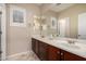 Bathroom featuring a large mirror, double sinks, and plenty of counter space at 9035 W Quail Track Dr, Peoria, AZ 85383