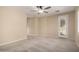 Neutral bedroom with carpet, ceiling fan, and door to outside at 9035 W Quail Track Dr, Peoria, AZ 85383