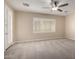 Bright bedroom with a ceiling fan, carpet flooring, and a large window at 9035 W Quail Track Dr, Peoria, AZ 85383