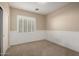 Bedroom with carpet, wainscoting and plantation shutters at 9035 W Quail Track Dr, Peoria, AZ 85383