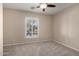 Bedroom with carpet, ceiling fan, and plantation shutters at 9035 W Quail Track Dr, Peoria, AZ 85383