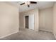 Neutral bedroom with carpet, ceiling fan, and closet at 9035 W Quail Track Dr, Peoria, AZ 85383