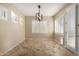 Bright dining room features modern lighting fixture, neutral walls, and tile flooring at 9035 W Quail Track Dr, Peoria, AZ 85383