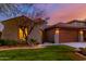 Charming single-Gathering home features a well-manicured lawn, neutral stucco, and a two-car garage at 9035 W Quail Track Dr, Peoria, AZ 85383