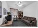 Comfortable living room with a striped sofa, a bookshelf, and a vintage television, creating a cozy and relaxed atmosphere at 9213 W Clara Ln, Peoria, AZ 85382