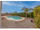 Backyard pool features desert landscaping and mature privacy hedges, creating an outdoor oasis at 9213 W Clara Ln, Peoria, AZ 85382