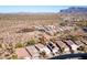 Aerial view of a desert neighborhood with beautiful mountain views, desert landscaping, and single Gathering homes at 9796 E Stone Cir Ln, Gold Canyon, AZ 85118