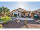 Gorgeous backyard featuring a pool, covered patio, desert landscaping, and outdoor seating at 9796 E Stone Cir Ln, Gold Canyon, AZ 85118