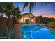 Inviting backyard pool with lush tropical landscaping, patio seating, and a tranquil desert vibe perfect for relaxing at 9796 E Stone Cir Ln, Gold Canyon, AZ 85118