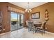 Cozy dining area with backyard access, chandelier, and views of the pool at 9796 E Stone Cir Ln, Gold Canyon, AZ 85118