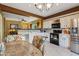 Bright kitchen boasts white cabinetry, stainless steel appliances, and a functional layout, seamlessly connecting to the dining area at 9796 E Stone Cir Ln, Gold Canyon, AZ 85118