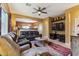 Inviting living room features plush leather seating, a ceiling fan, and an open layout, perfect for entertaining and relaxation at 9796 E Stone Cir Ln, Gold Canyon, AZ 85118