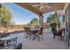 A covered patio with outdoor seating provides an excellent space to dine and view the beautiful desert landscape at 9796 E Stone Cir Ln, Gold Canyon, AZ 85118