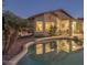 Backyard oasis featuring a refreshing pool, covered patio, and relaxed seating area at 9796 E Stone Cir Ln, Gold Canyon, AZ 85118