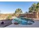 Refreshing private pool surrounded by lush palm trees and desert landscaping in backyard at 9796 E Stone Cir Ln, Gold Canyon, AZ 85118