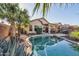 Sparkling pool with mature landscaping and serene backyard oasis at 9796 E Stone Cir Ln, Gold Canyon, AZ 85118