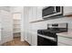 Kitchen featuring white cabinets, stainless steel appliances, and a pantry at 9849 S Caballo Dr, Apache Junction, AZ 85120