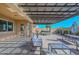 Comfortable outdoor seating area with an outdoor kitchen and hot tub, covered by a modern pergola at 10039 W Jasmine Trl, Peoria, AZ 85383