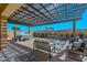 Inviting back patio featuring comfortable seating, a hot tub, and a stylish pergola, ideal for relaxation at 10039 W Jasmine Trl, Peoria, AZ 85383