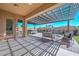 Beautifully designed back patio with comfortable seating, hot tub and modern pergola perfect for outdoor entertaining at 10039 W Jasmine Trl, Peoria, AZ 85383