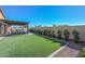 Spacious backyard featuring artificial turf, a pergola-covered patio, and a privacy wall at 10039 W Jasmine Trl, Peoria, AZ 85383