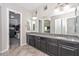 Primary bath featuring granite counters, dual sinks and walk in closet at 10039 W Jasmine Trl, Peoria, AZ 85383