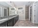 Primary bath featuring granite counters, dual sinks and decorative backsplash at 10039 W Jasmine Trl, Peoria, AZ 85383