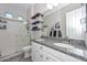 Bright bathroom with double sinks, granite countertops, and a glass-enclosed shower at 10039 W Jasmine Trl, Peoria, AZ 85383