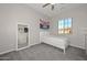 Cozy bedroom with a window providing natural light, carpeted flooring, and simple decor at 10039 W Jasmine Trl, Peoria, AZ 85383
