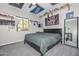 Unique bedroom design featuring shelves displaying hats, a window, carpet flooring, and sporty decorations at 10039 W Jasmine Trl, Peoria, AZ 85383