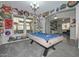 Spacious game room featuring a pool table and unique wall decor, perfect for entertaining guests at 10039 W Jasmine Trl, Peoria, AZ 85383